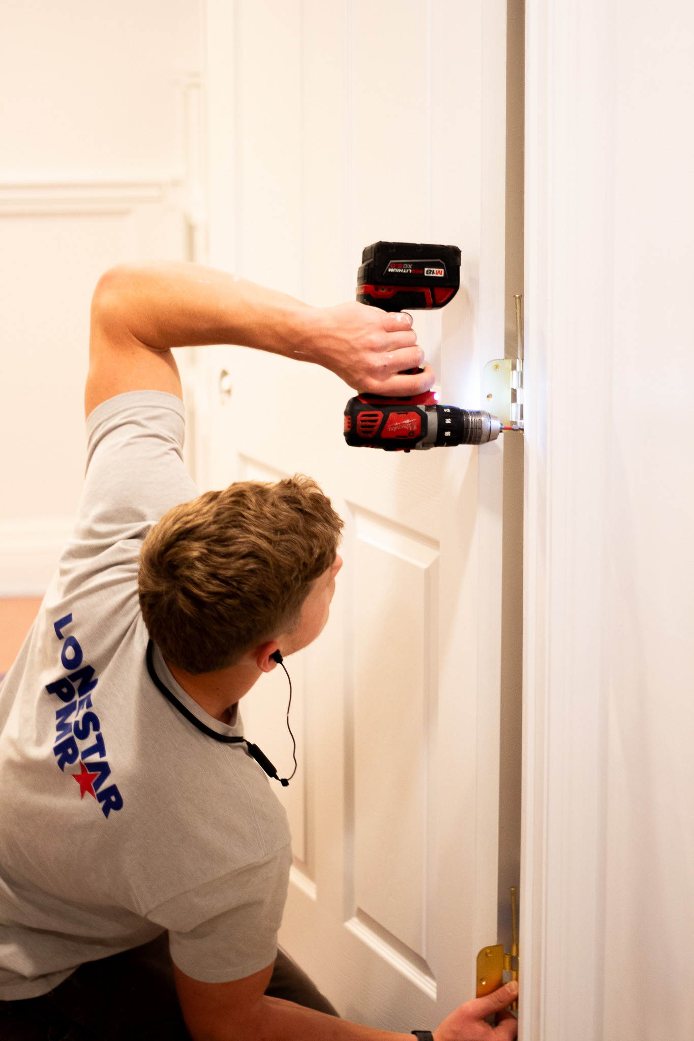 Campbell Day installing trim with a drill